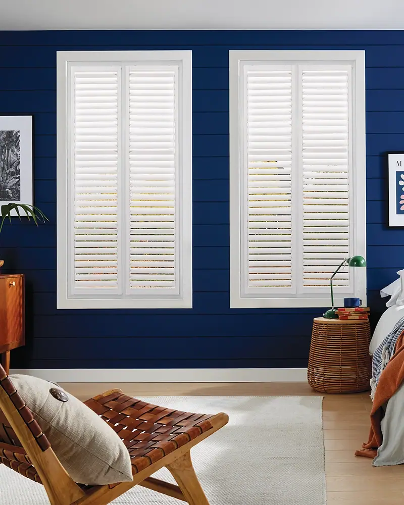 White DIY shutters in a bedroom with a navy wall